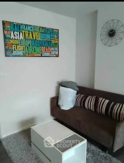 Cozy living room with modern decor and travel-themed wall art