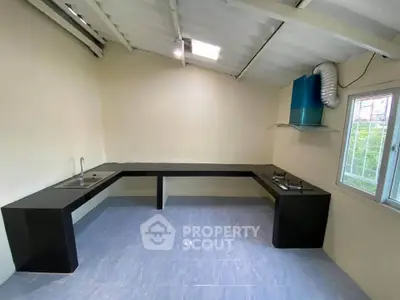 Spacious kitchen with sleek countertops and gas stove, perfect for modern culinary adventures.