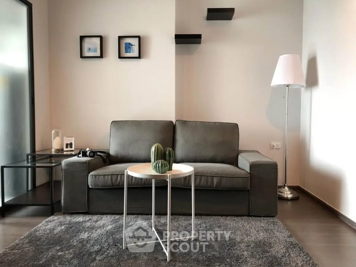 Modern living room with stylish gray sofa, sleek coffee table, and contemporary decor.