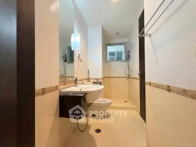 Modern bathroom with sleek fixtures and spacious shower area in a contemporary home.