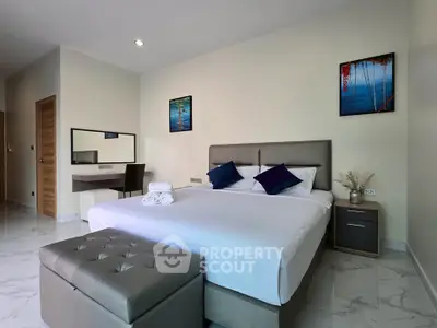 Spacious modern bedroom with elegant decor and natural light
