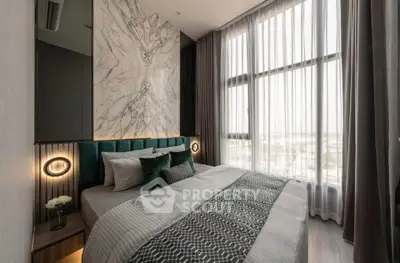 Luxurious bedroom with floor-to-ceiling windows and elegant decor in modern apartment.