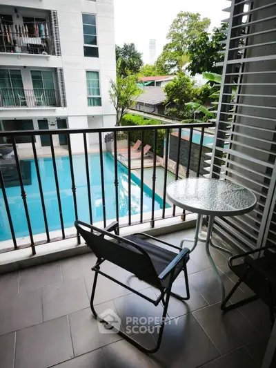 Charming balcony with pool view in modern apartment complex