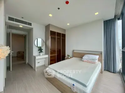 Modern bedroom with large window and wooden furniture in high-rise apartment.
