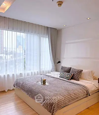 Modern bedroom with large window and stylish decor in urban apartment