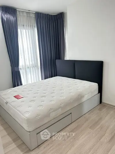 Modern bedroom with stylish bed and elegant curtains in a bright apartment.