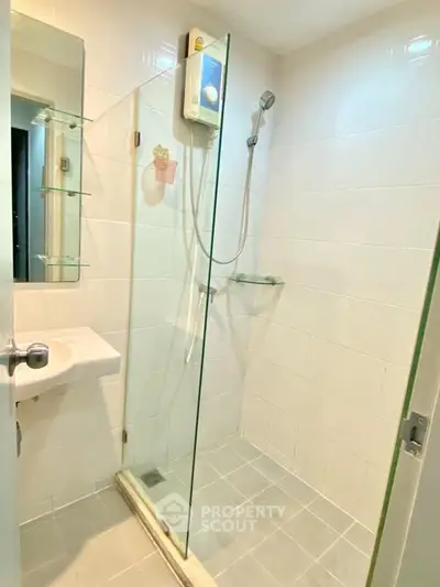 Modern bathroom with glass shower enclosure and sleek fixtures