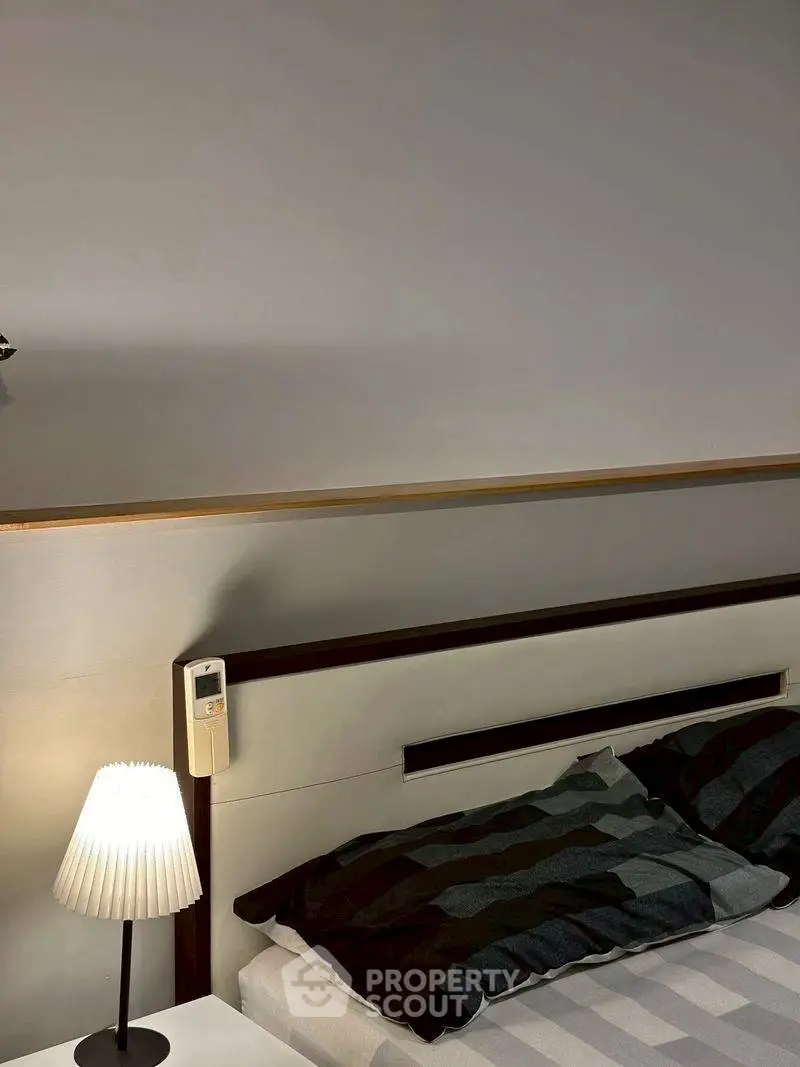 Modern bedroom with stylish lamp and cozy bedding