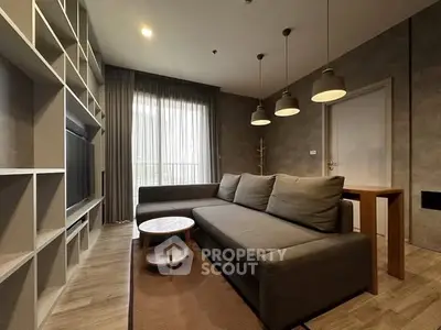 Modern living room with stylish sofa and shelving unit, perfect for relaxation and entertainment.