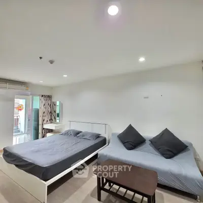 Spacious bedroom with modern furnishings and natural light