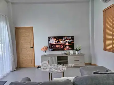 Modern living room with cozy sofa and TV setup, perfect for relaxation.