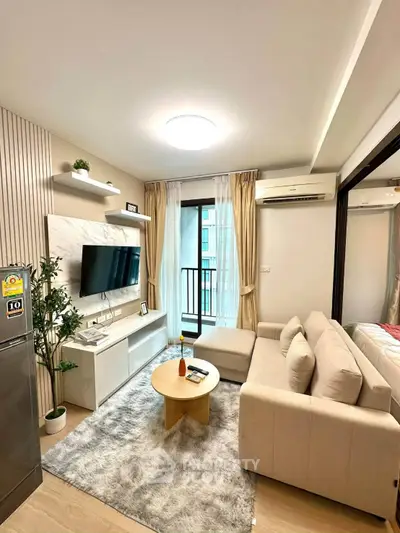 Modern living room with cozy beige sofa, wall-mounted TV, and balcony view in stylish apartment.