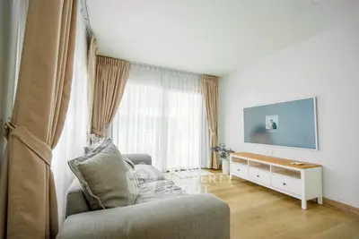 Bright living room with modern decor and large windows