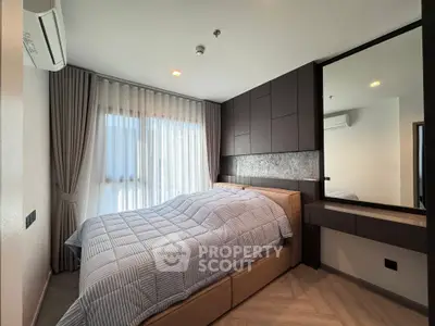 Modern bedroom with stylish decor and large window for natural light