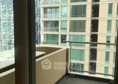 Modern apartment balcony with glass railing and city view