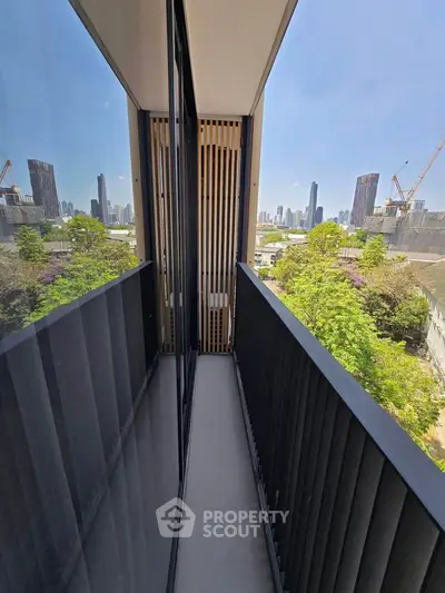 Modern apartment balcony with stunning city skyline view and sleek railing design.