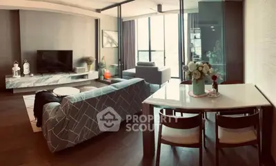 Modern living room with stylish furniture and large windows offering natural light.