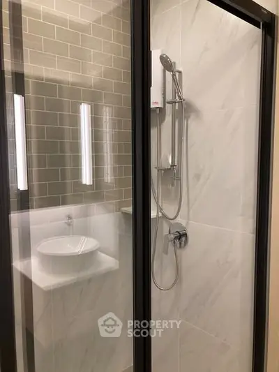 Modern bathroom with sleek shower and stylish sink in contemporary design.