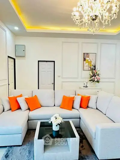 Elegant living room with modern sectional sofa and chandelier lighting