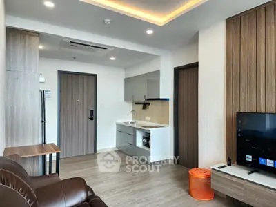 Modern living room with sleek kitchen and stylish decor