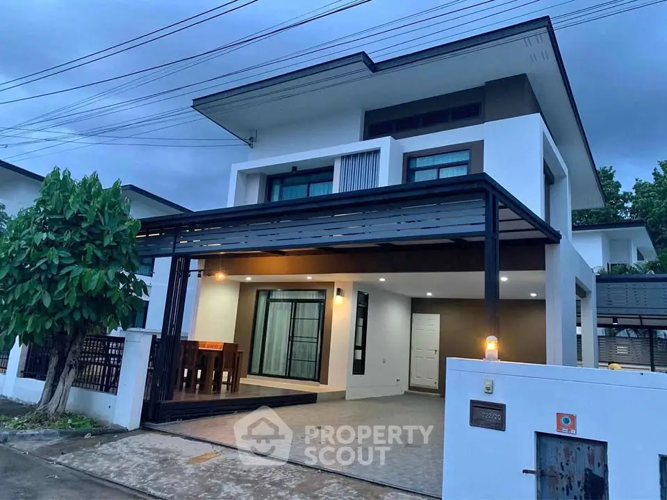 Modern two-story house with spacious driveway and sleek exterior design.