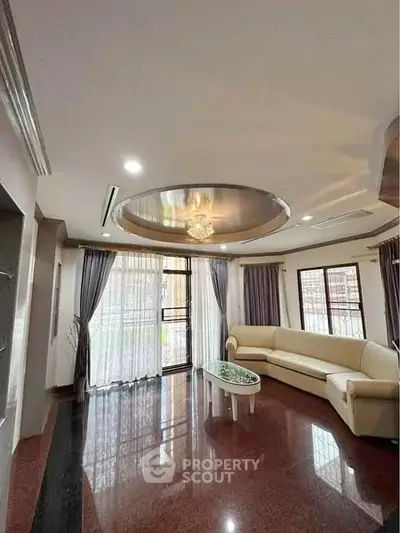 Elegant living room with modern ceiling design and cozy seating area.