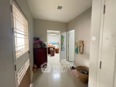 Spacious entryway leading to a cozy living area with modern decor