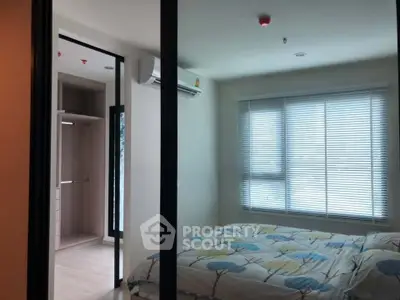 Cozy bedroom with walk-in closet and large window for natural light