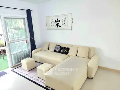 Cozy living room with modern beige sofa and artistic wall decor