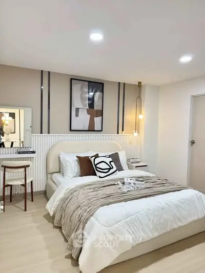 Modern bedroom with stylish decor and cozy ambiance, featuring elegant lighting and contemporary artwork.