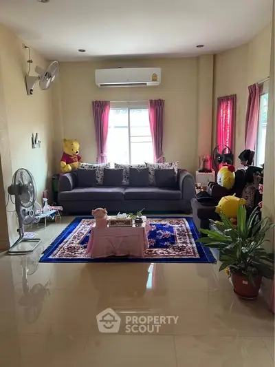 Charming living room with cozy sofa, vibrant decor, and natural light, perfect for relaxation and entertaining.