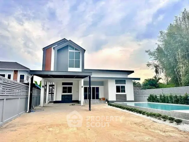 Modern two-story house with sleek design and private pool in spacious yard.