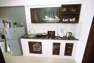 Modern kitchen with sleek cabinets, appliances, and stylish decor in a compact layout.