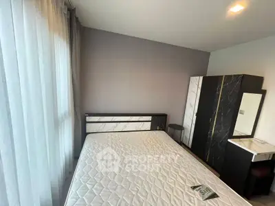 Modern bedroom with stylish furniture and large window for natural light