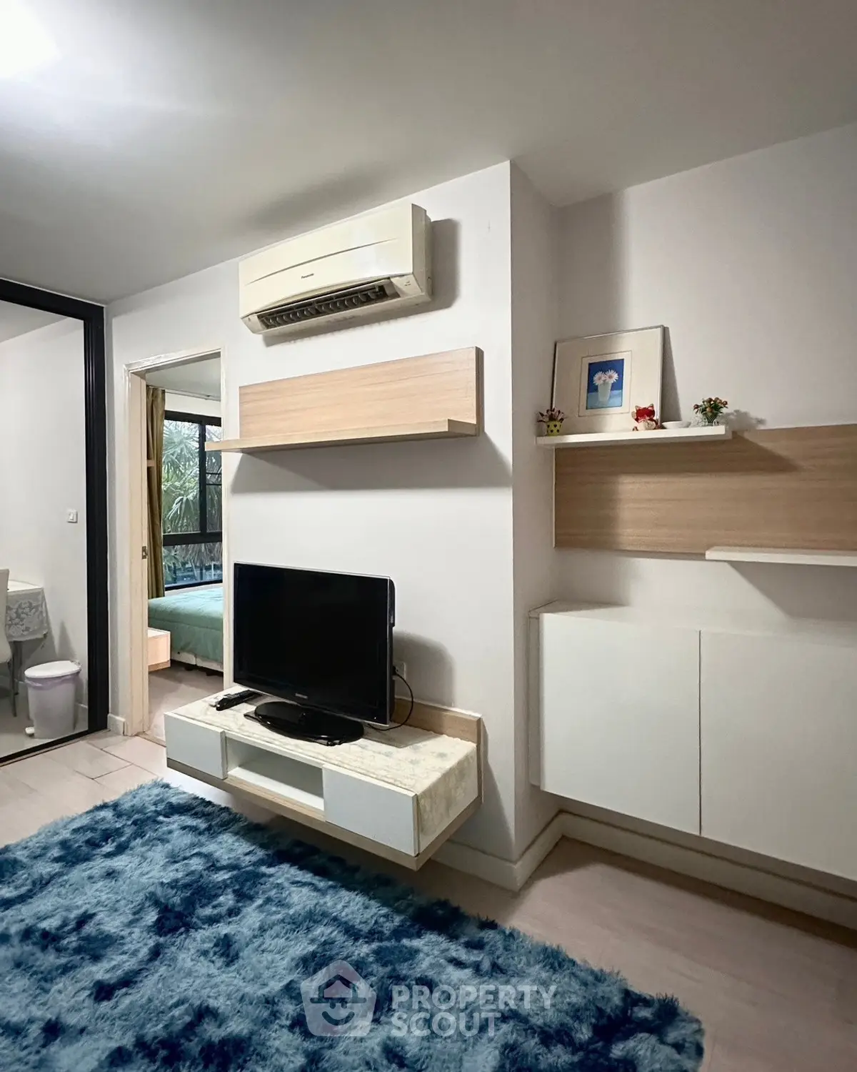 Modern living room with air conditioning and stylish decor in a cozy apartment.