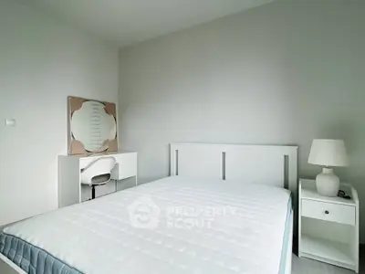 Minimalist bedroom with white furniture and cozy ambiance