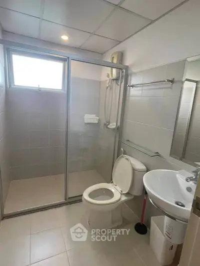 Modern bathroom with glass shower enclosure and sleek fixtures