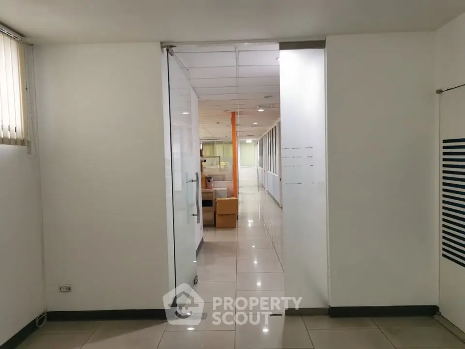 Spacious office corridor with glass partitions and modern design