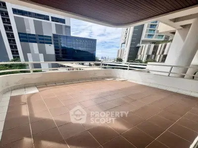 Spacious balcony with city view in modern apartment building