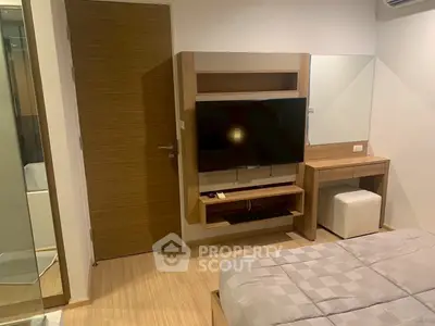 Modern bedroom with sleek wooden furniture and wall-mounted TV