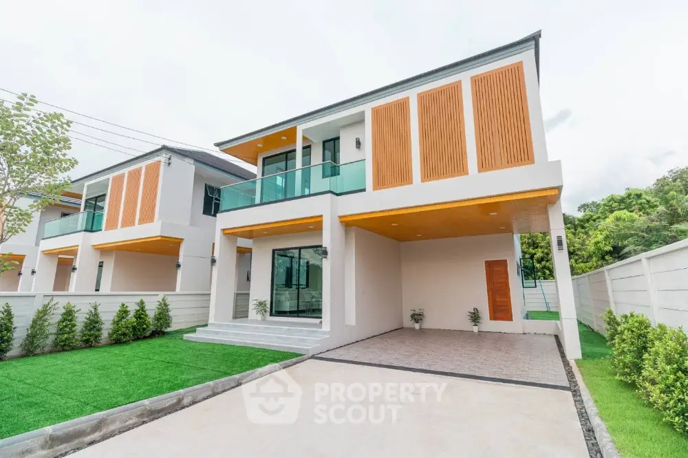 Modern two-story house with spacious driveway and lush green lawn