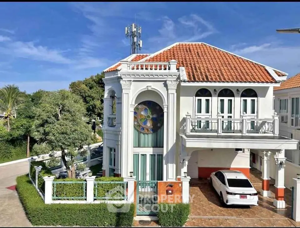 Stunning Mediterranean-style villa with red-tiled roof and spacious driveway