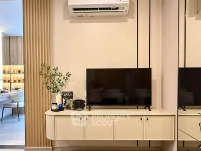 Modern living room with sleek TV unit and air conditioning, showcasing contemporary interior design.