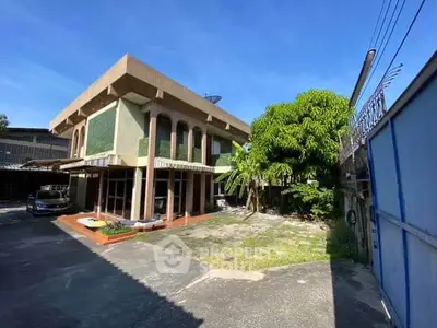 Spacious two-story house with lush garden and ample parking space, perfect for family living.