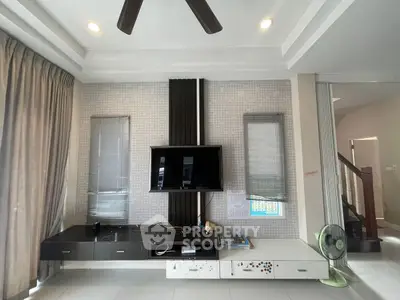 Modern living room with wall-mounted TV and stylish decor