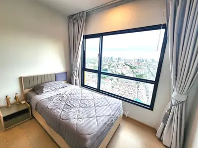 Stunning bedroom with panoramic city view from large window, modern decor and cozy ambiance.