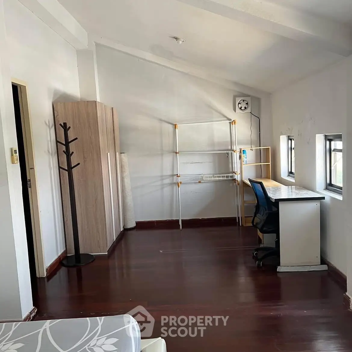 Spacious study room with modern desk and ample natural light.