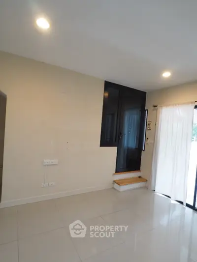 Modern interior space with sleek design and natural light, featuring a unique elevated window.