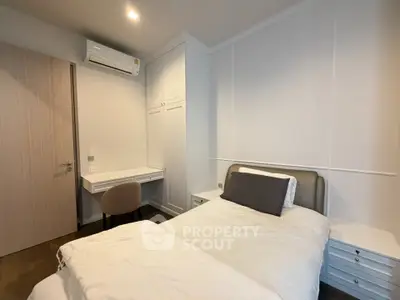 Modern bedroom with sleek design, featuring a comfortable bed, built-in wardrobe, and a cozy study nook.