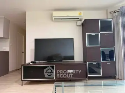 Modern living room with sleek TV unit and air conditioning, perfect for comfortable living.